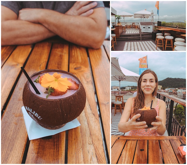 Drink in coconut cup on rooftop bar in Panama City