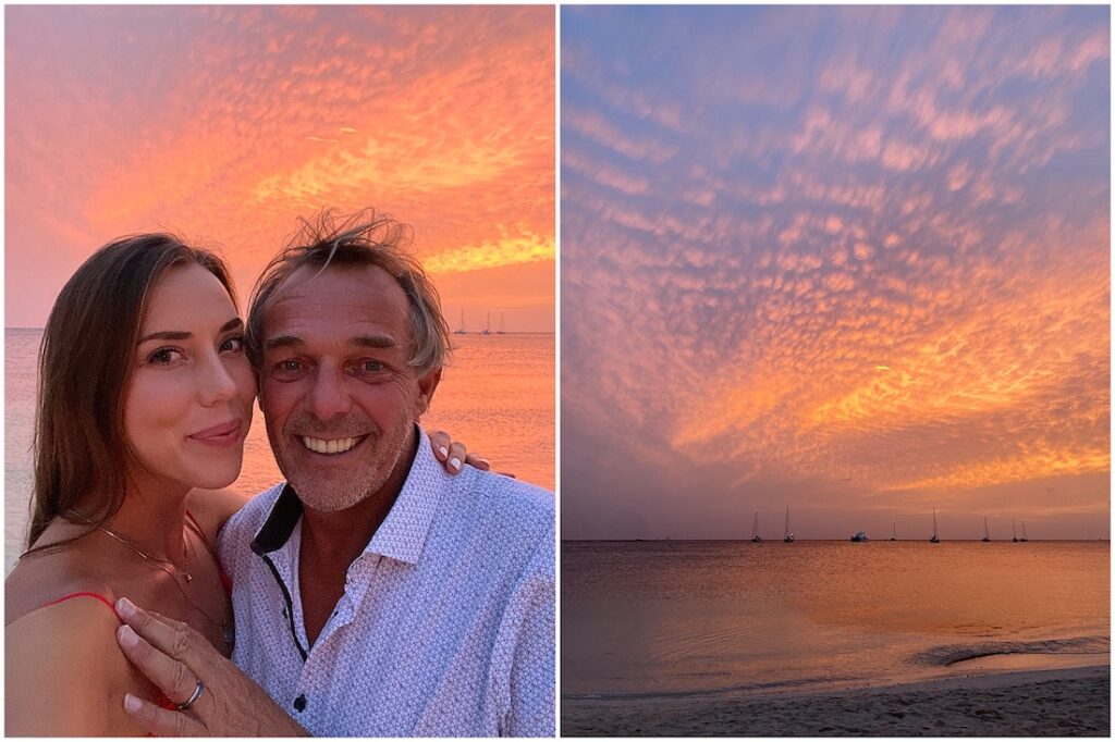 an age gap couple on the beach watching a sunset